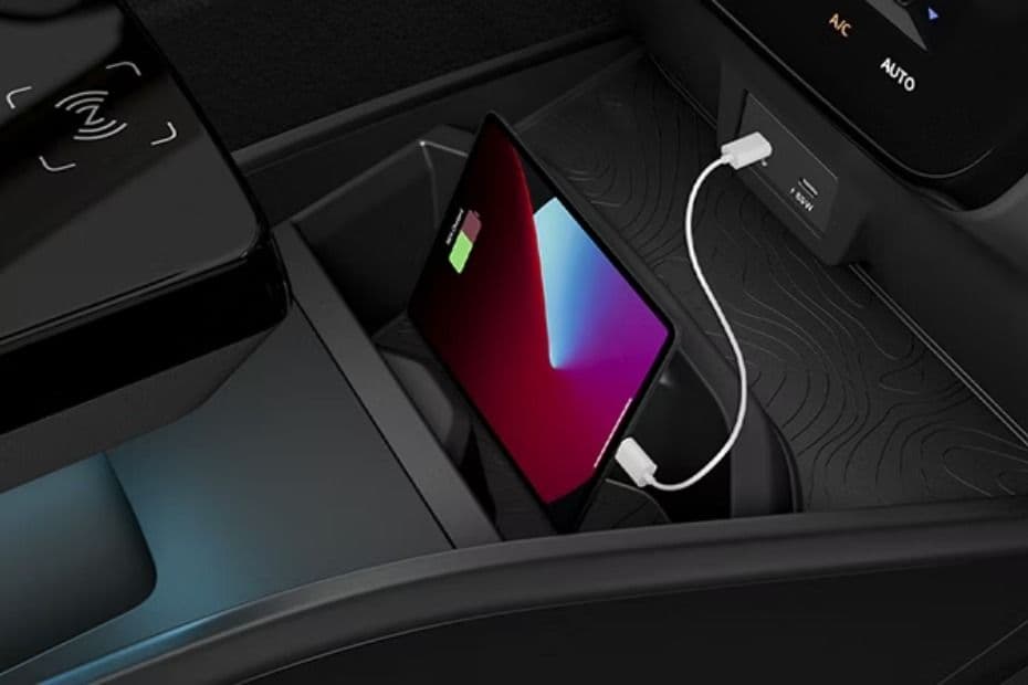 Front centre console USB charging port connected to a device inside the Sierra EV