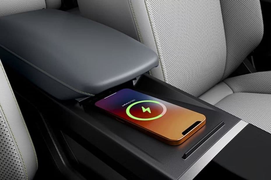 Smartphone placed on the wireless charging pad in the centre console
