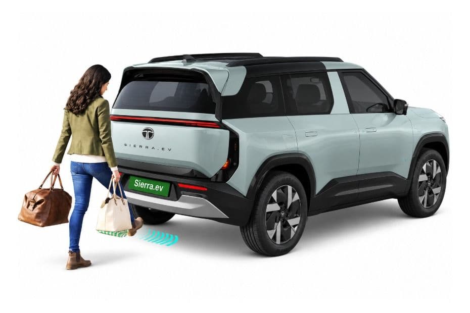 Sierra EV powered tailgate opening with a foot gesture shown beneath the rear bumper