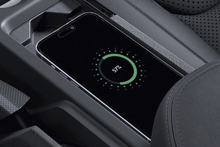 Centre console showing a smartphone placed on the wireless charging pad