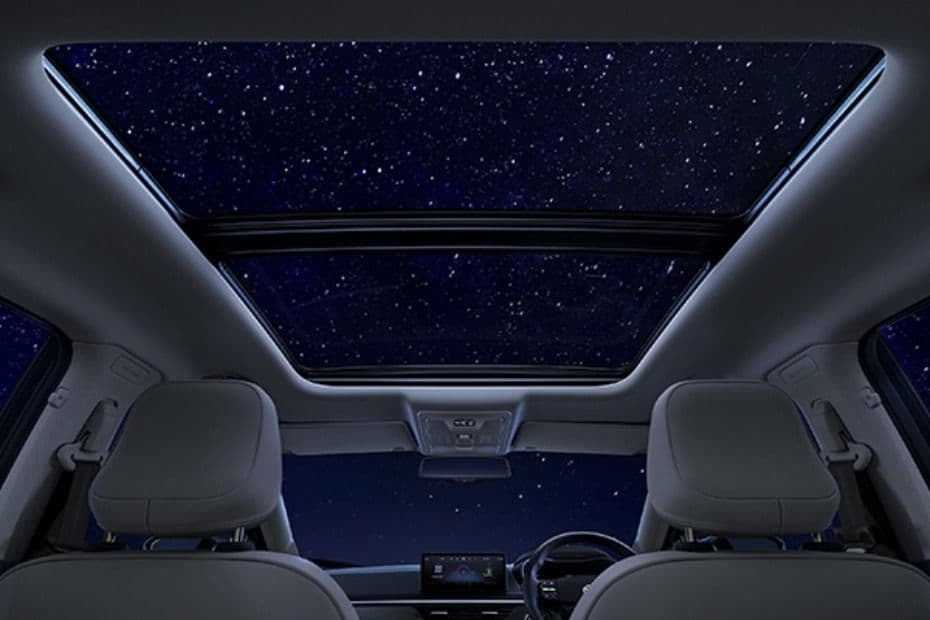 Cabin view showing the panoramic sunroof extending over the front and rear seats
